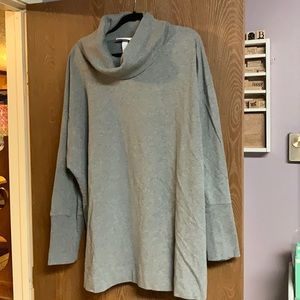 Grey cowl neck top with exaggerated cuffs.